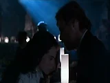 Mia Kirshner dancing for a guy at a strip club, wearing a