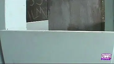 While her man waits in the car the naughty blonde sucks cock in the gloryhole