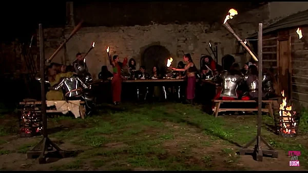 A medieval collective sexual gathering takes place in the vicinity of a castle, under the celestial canopy